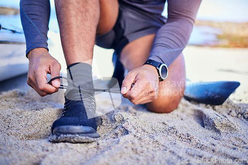 Image of Hands tie shoes, ocean and athlete start workout, training and kayak exercise outdoor. Sand, person and tying sneakers at beach to prepare for fitness, sports and healthy body for wellness in summer.
