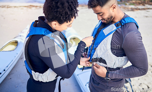 Image of Life jackets, safety and couple prepare for water, boat and journey on river with protection or people on lake adventure together. Lifejacket, man and woman or instructor helping with sport vest