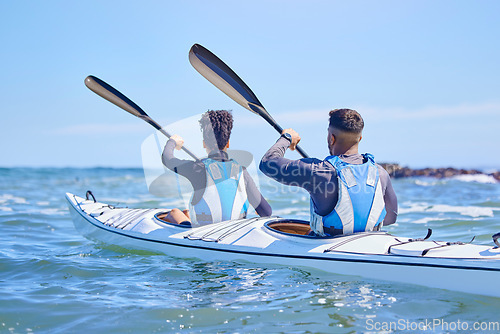 Image of Water, man and woman in kayak and sports on lake, beach or river for exercise together on vacation. Ocean holiday, adventure and fitness, couple in canoe for training workout in teamwork on blue sky.