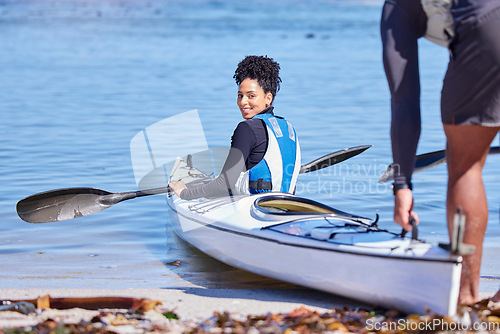 Image of Water, portrait of woman in kayak and getting ready at lake, beach or river for exercise with smile. Ocean holiday, adventure and fitness, happy couple in canoe for training workout for sports at sea