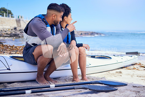 Image of Couple, talking and outdoor for kayak or travel at a beach with a partner for teamwork. A man and woman with a canoe for sports, water adventure and vacation or freedom pointing at space in nature