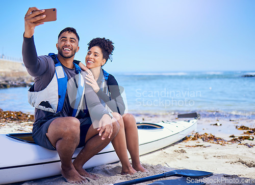 Image of Selfie, kayak and a couple on the beach in summer together for freedom, vacation or holiday travel. Relax, love or smile with a sports man and woman on a boat by the ocean or sea for adventure