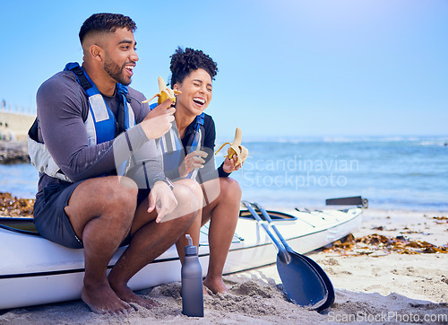 Image of Kayak, couple and eating banana at beach, funny and bonding together on mockup space. Fruit, laugh and man and woman on boat at ocean, canoeing sport and happy with nutrition, fitness or healthy body