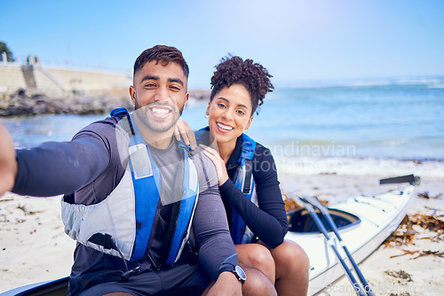 Image of Selfie, kayak and a couple on the beach to relax in summer together for freedom, vacation or holiday travel. Portrait, love or smile with a sports man and woman on a boat by the ocean for adventure