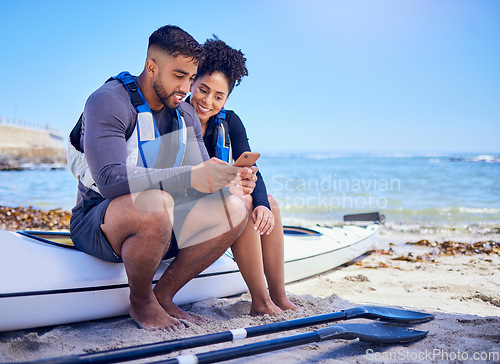 Image of Couple, phone and outdoor for kayak or travel at a beach with internet connection or chat. A man and woman with a smartphone for social media, streaming water sports video and canoe space in nature