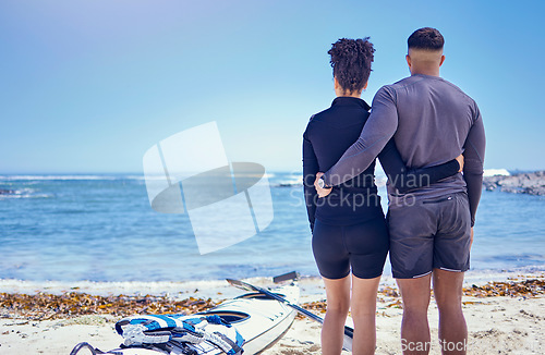 Image of Couple, kayak and outdoor for travel adventure at a beach with a partner for teamwork. Behind a man and woman with a canoe for water sports, banner space in sky and vacation or freedom in nature