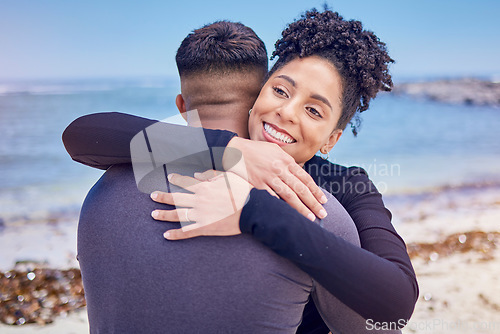 Image of Fitness, face and couple hug at a beach for sports, training and morning cardio in nature. Love, smile and happy woman embrace man at the ocean for running, workout or wellness exercise with support