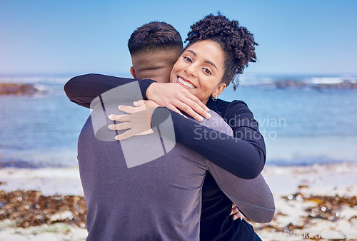 Image of Fitness, portrait and couple hug at a beach for sports, training and morning cardio in nature. Face, smile and happy woman embrace man at the ocean for running, workout or wellness exercise with love