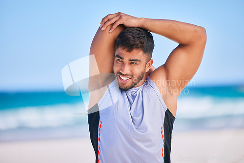 Image of Happy man, stretching and fitness on beach for workout, exercise or outdoor training in sports. Muscular, athlete or sporty male person smile in body warm up or preparation on ocean coast in nature