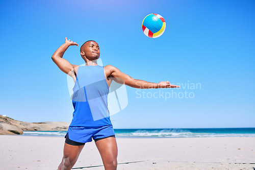 Image of Beach volleyball, sports and black man serve ball, play competition and athlete training in outdoor challenge. Blue sky, freedom and African player workout, exercise and start game, match or practice