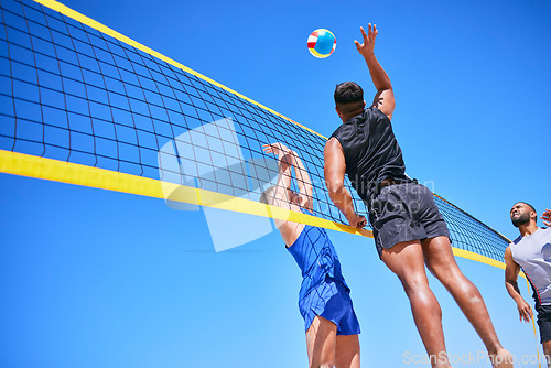 Image of Beach volleyball match, blue sky and sports team jump, playing competition and practice for tournament challenge. Below view, athlete action and people in air workout, training or nature exercise