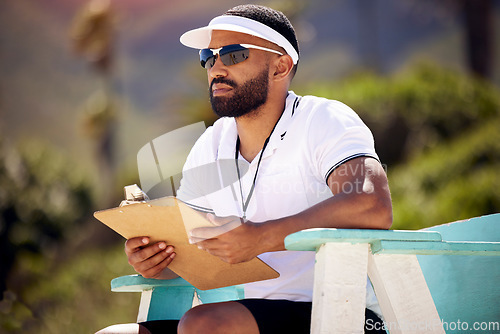 Image of Summer, clipboard and a volleyball referee on the beach in a chair for authority, rules or regulations during a game. Health, documents or competition with a man refereeing a match in the day