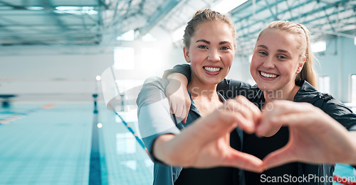 Image of Happy woman, swimming and heart hands in support, teamwork or care in sport fitness together at pool. Female person or professional swimmer with loving emoji, shape or symbol in team exercise or goal