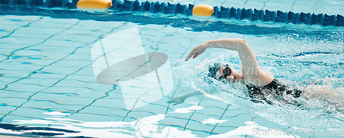 Image of Sports, swimming and woman athlete training for a race, competition or tournament in a pool. Fitness, workout and female swimmer practicing a cardio water skill for exercise, speed or endurance.