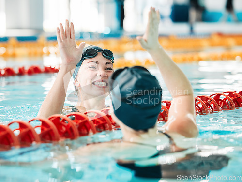 Image of Fitness, swimmer and women with high five, celebration and achievement with workout, wellness and winning. Exercise, winner or champion in a pool, celebration or support with success, sports or smile