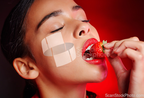 Image of Face, eating and woman with red strawberry for fruit detox, health wellness goals or nutritionist diet. Lipstick makeup, erotic. beauty and sexy model girl with food product, skincare and cosmetics