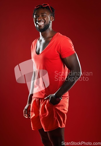 Image of Black man, studio portrait and sport clothes with smile, sunglasses or happiness by red background. Model, man and happy with summer fashion, beauty and sports style for health, self care or wellness