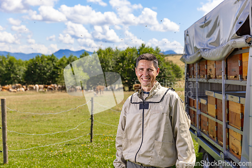 Image of Portrait of a happy male beekeeper