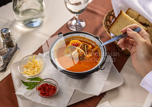 Image of Fresh fish soup in small cauldron