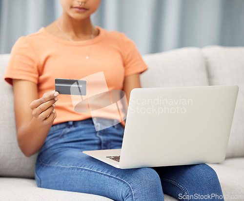 Image of Black woman on sofa, laptop and credit card for finance, budget and check investments in lounge. Computer, female and girl in living room, online banking and transactions for payments and ecommerce