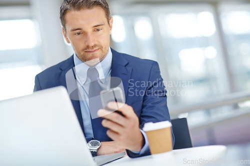 Image of Thinking, corporate or business man with phone in office for communication, social networking or content blog review. Laptop or manager with smartphone for social media, mobile or web app search