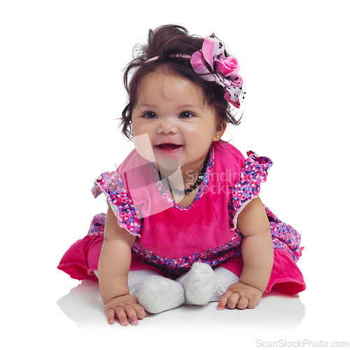 Image of Innocent, cute and happy baby girl in a studio with a floral, beautiful and flower outfit and headband. Happiness, smile and infant child sitting and playing while isolated by a white background.