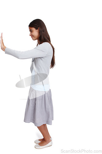 Image of Push, move and mockup with a woman in studio isolated on a white background moving a poster or billboard. Mock up, effort and pushing with an attractive young female standing alone on blank space