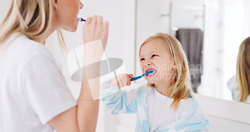 Image of Development, mother and girl in bathroom with brush for teeth doing bonding, embrace and loving together. Female parent, lady and kid or child brushing teeth, dental hygiene and child growth at home.