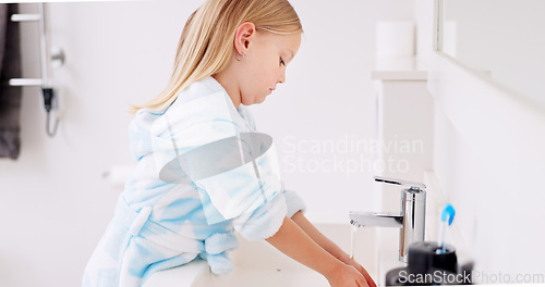 Image of Cleaning, child and girl washing hands in the bathroom with soap for hygiene, healthcare and independence at home. Young, water and healthy kid doing sanitary routine at a sink for toxic bacteria