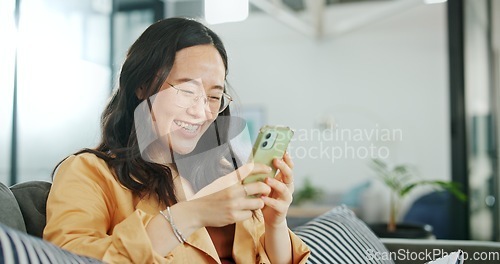 Image of Phone communication, talking and asian woman at home on a sofa with a online conversation. Phone call, speaking and networking of a person on a mobile phone at a living room house on a couch