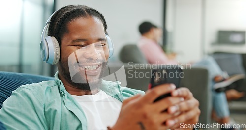 Image of Laugh, happy and mobile text of a black man typing on social media communication app. Laughing, internet scroll and web meme of a man online on a mobile phone texting and reading a funny joke