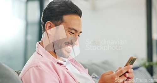 Image of Phone, sofa and happy man in living room on social media, texting or web scrolling. Relax, cellphone and male on couch in home with mobile smartphone for networking, internet browsing or messaging.