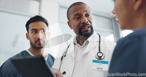 Image of Tablet, nurses and doctor talking in hospital, discussing research or medical records. Wellness, digital tech and group of physicians, men and women chatting about online healthcare results in clinic