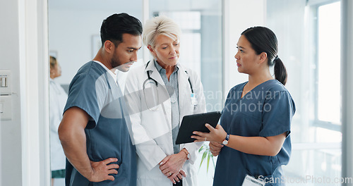 Image of Doctor, team and tablet in discussion with senior for healthcare training, advise or support at hospital. Medical professionals with touchscreen in conversation, collaboration or teamwork at clinic