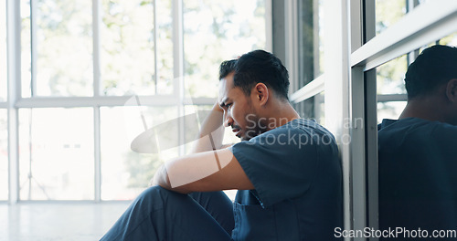 Image of Nurse, stress or depression man on hospital floor in virus death, surgery fail or patient loss grief in Japanese clinic. Mental health, sad or anxiety for crying healthcare worker in medical burnout