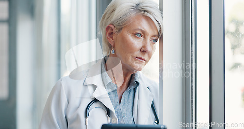 Image of Stress, woman or doctor thinking at window with burnout in hospital office after surgery. Medicine, anxiety and mental health, senior medical professional in Canada tired from overtime or depression.