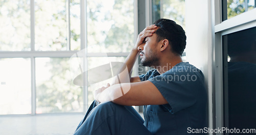 Image of Nurse, stress or depression man on hospital floor in virus death, surgery fail or patient loss grief in Japanese clinic. Mental health, sad or anxiety for crying healthcare worker in medical burnout