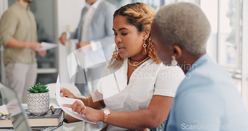 Image of Teamwork, documents and business women review, discussion, and comparing data together. Paperwork, collaboration and cooperation of black women or employees planning sales growth strategy in office.