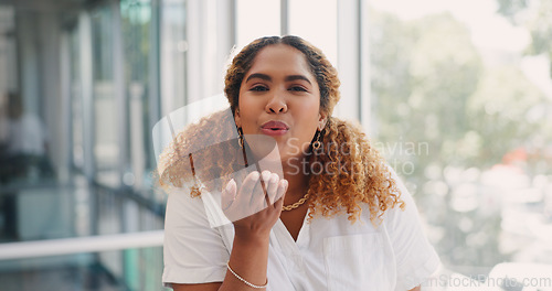 Image of Office, face and happy woman blowing a kiss while working on a creative, marketing or advertising project. Creativity, happiness and professional female employee from Mexico flirting in her workplace