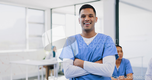 Image of Face, healthcare and insurance with a nurse man standing arms crossed in a hospital for medical treatment. Portrait, doctor and trust with a male medicine professional in a clinic for diagnosis