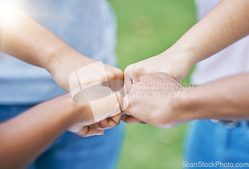 Image of People, hands and fist bump in collaboration for community, partnership or trust together in the outdoors. Hand of team bumping fists in unity for agreement, coordination or support in solidarity