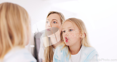 Image of Happy, funny faces and mother with a child looking in the mirror while making a comic joke. Happiness, smile and young mom having comedy fun with her daughter at their family home in Australia.