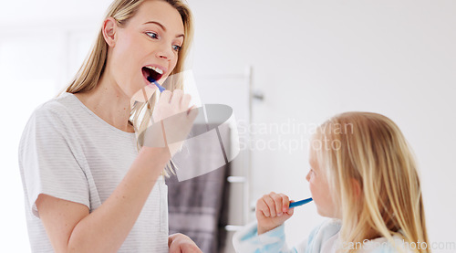 Image of Toothbrush, mother and girl cleaning their teeth in the morning in the bathroom of their family home. Happy, bond and mom doing a dental hygiene routine for health with oral products with her child.