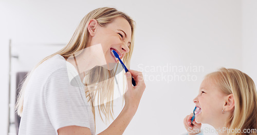 Image of Toothbrush, mother and girl cleaning their teeth in the morning in the bathroom of their family home. Happy, bond and mom doing a dental hygiene routine for health with oral products with her child.