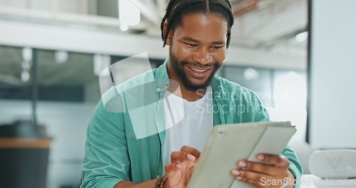 Image of Tablet, business and black man typing in office, social media or research. Break, technology and happy male employee holding digital touchscreen for networking, internet browsing or web scrolling.
