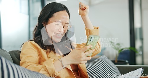 Image of Business woman, phone or success fist on working office sofa, digital marketing startup or Asian advertising company. Smile, happy or winner creative designer on mobile technology or cheering goals