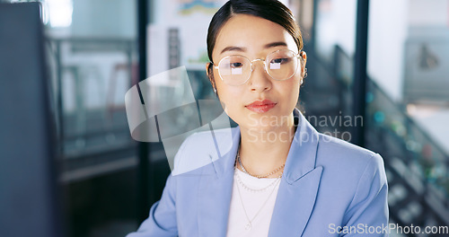 Image of Computer, office and Asian business woman with glasses typing and planning a corporate project. Success, professional and professional employee working on a company report, document or proposal on pc