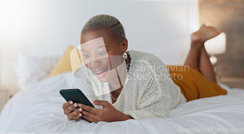 Image of Bed, phone and a black woman surfing social media and laughing at funny video. Relax, browse and click like on post on internet. Laugh and smile at streaming site for entertainment online in bedroom.