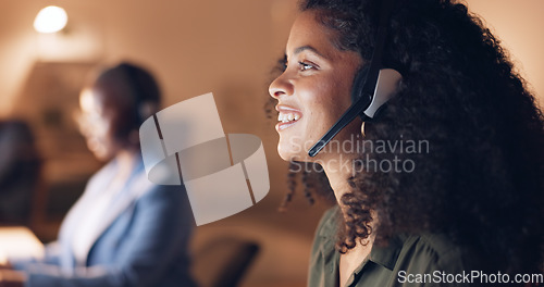 Image of Call center, night and black woman consulting with people online in a dark office. Face of an African customer service worker talking, working and giving support with a headset during overtime