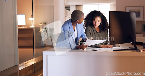 Image of Business woman coaching worker at night modern office, planning documents research and company strategy. Female team employees working overtime on report collaboration, idea analysis and conversation